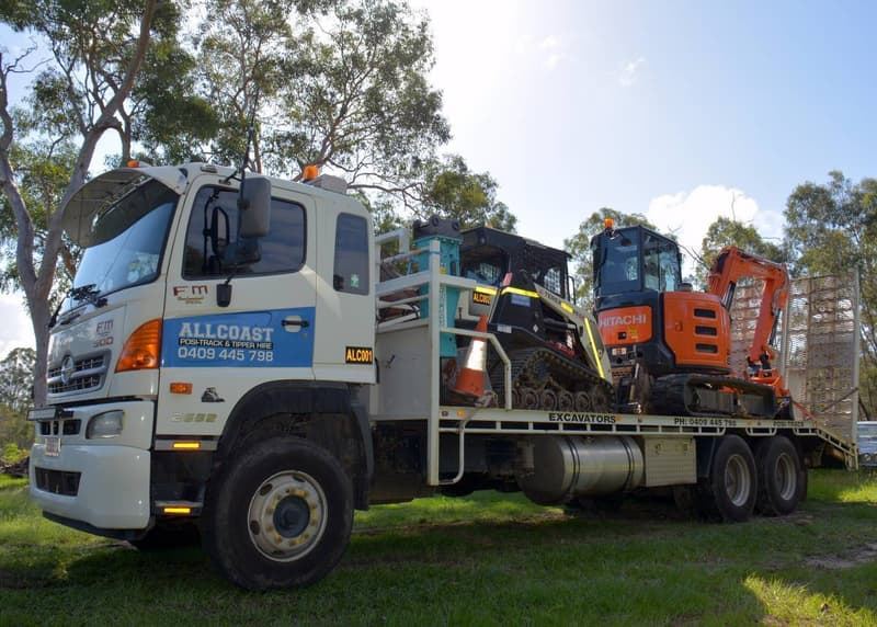Allcoast Hino truck carrying the RT-60 Posi-Track and Hitachi excavator